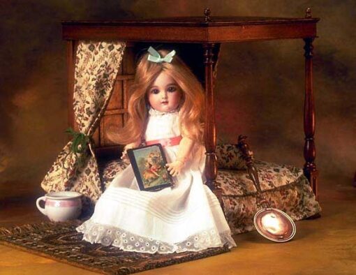 A doll sitting on top of a wooden chair.
