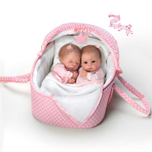 A baby doll in a pink basket with two babies.