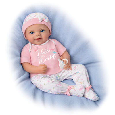 A baby doll wearing pink pajamas and hat.