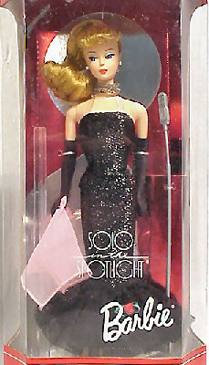 A doll in a black dress and gloves