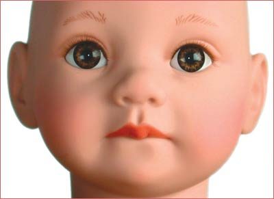 A doll with big eyes and pink lips.