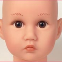 A baby with very long, thin eyebrows.