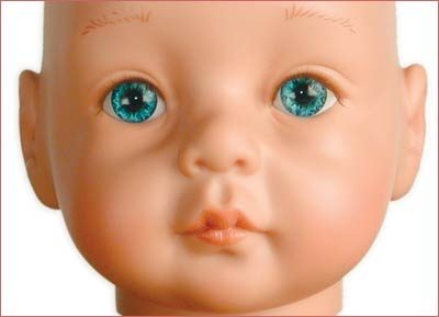 A doll with blue eyes and pink lips.