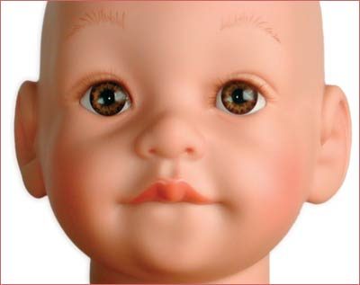 A doll 's head with brown eyes and pink hair.