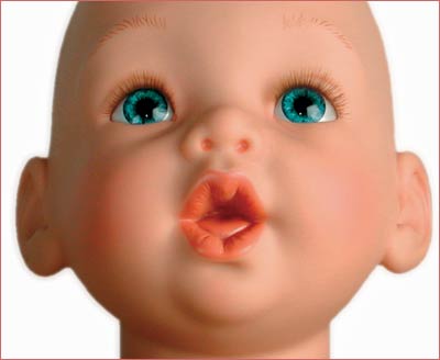 A baby doll with blue eyes and pink lips.