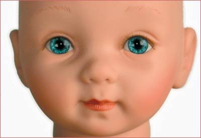 A doll with blue eyes and orange hair.