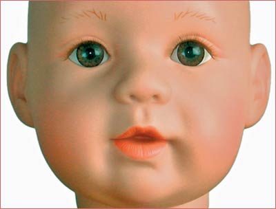 A close up of the face of an infant doll