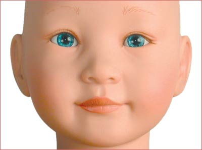 A close up of the face of an infant doll