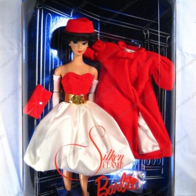 A barbie doll wearing a red hat and dress.