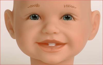A close up of a baby with a tooth brush in its mouth