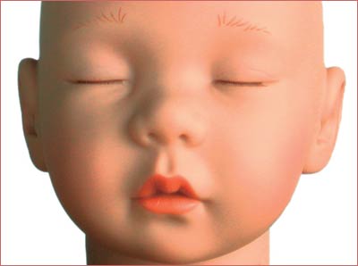 A close up of the face of a baby doll