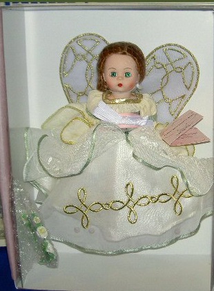 A close up of a doll in a dress