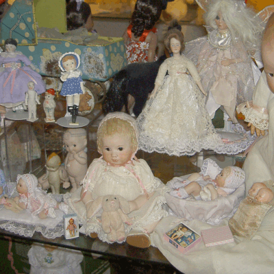A display case filled with lots of dolls.