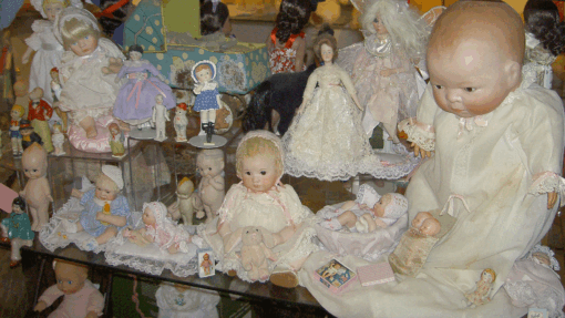 A display case filled with lots of dolls.