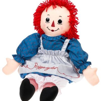 A raggedy ann doll with red hair and blue dress.