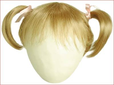 A girl 's head with two pigtails and blonde hair.