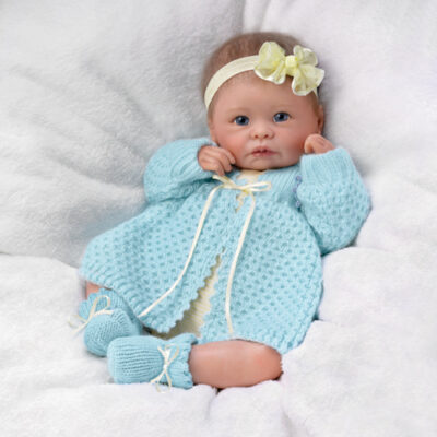 A baby doll wearing blue clothes and shoes.