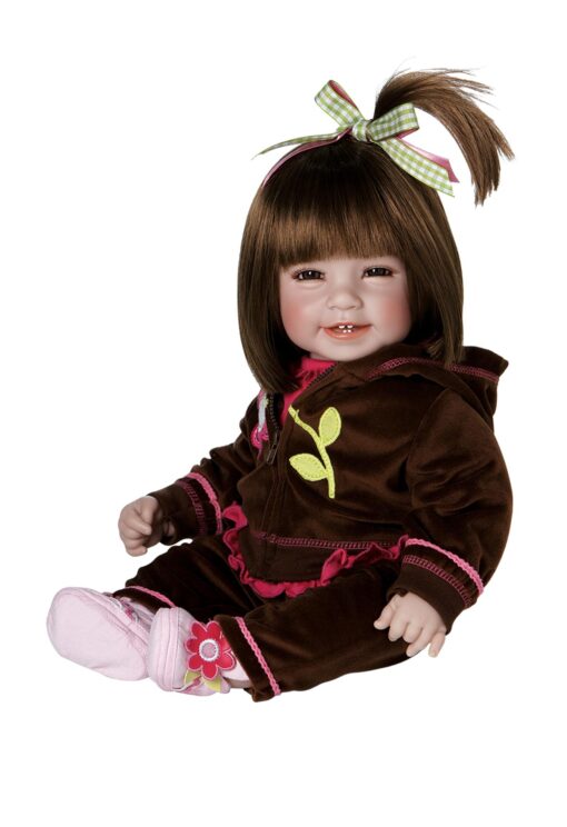 A doll that is sitting down and wearing a brown outfit.