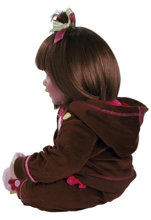 A close up of a doll wearing a brown jacket