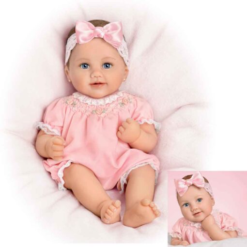 A baby doll wearing pink clothes and headband.