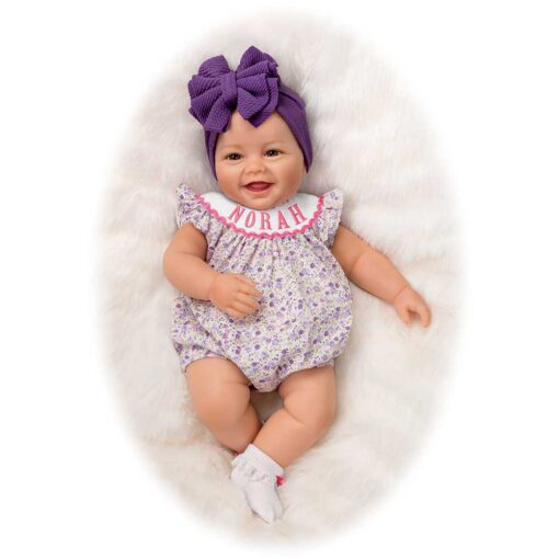 A baby doll with purple hair and a bow on its head.