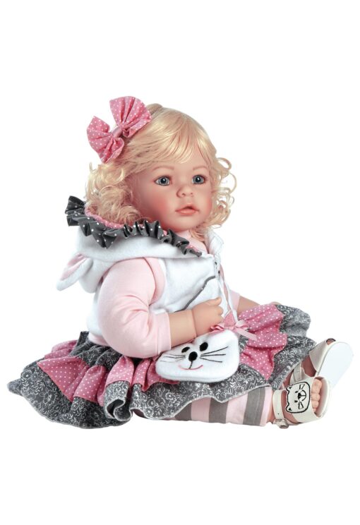 A doll that is sitting down and holding something.